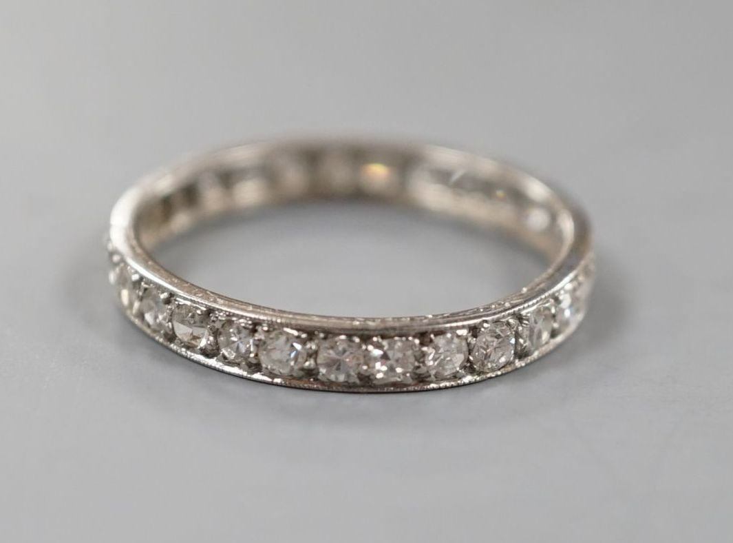 A white metal and diamond set full eternity ring, size Q, gross weight 2 grams.